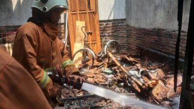 Petugas pemadam kebakaran berusaha memadamkan api yang melahap rumah di Ngoro kabupaten Mojokerto, Selasa (3/10/2023). (Erik/KabarTerdepan.com) 