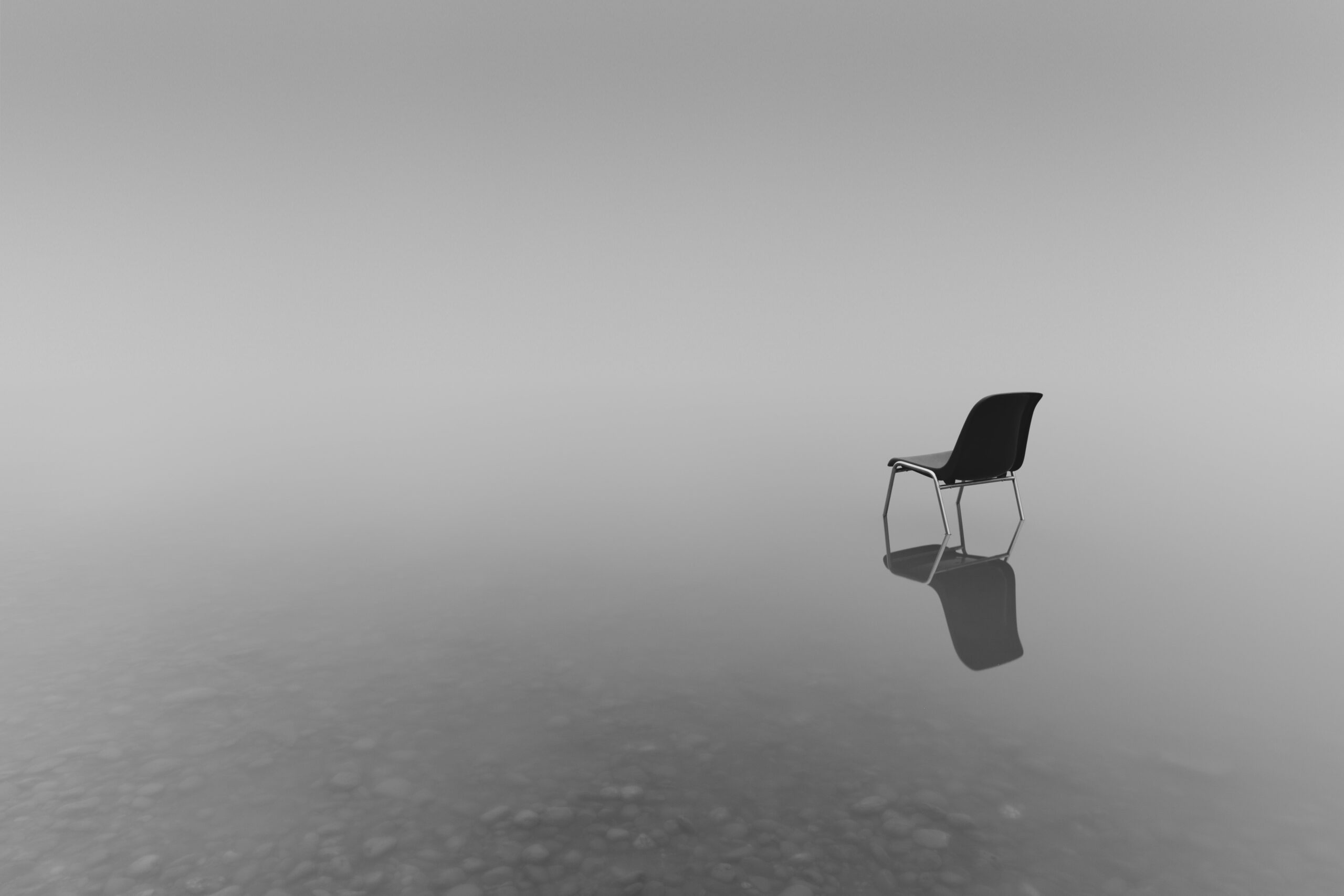 grayscale shot chair small pond concept loneliness min scaled