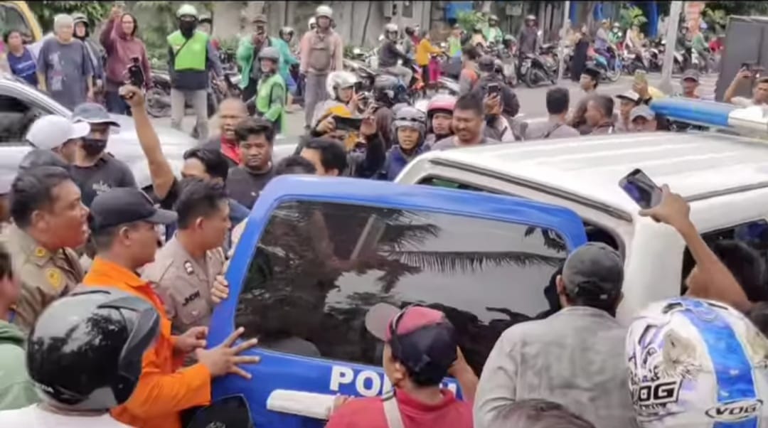 Polisi evakuasi terduga pencuri dan mengatakan ke mobil patrili Polsek Kenjeran Surabaya, Senin (18/3/2024). (Catur/kabarterdepan.com) 