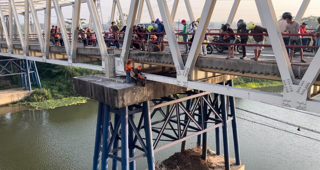 Petugas berusaha mengevakuasi korban yang hendak mengakhiri hidupnya dengan melompat dari jembatan sungai Brantas di Desa Ngrame, Kecamatan Pungging, Kabupaten Mojokerto, Jumat (8/11/2024) (Andy / Kabarterdepan.com)