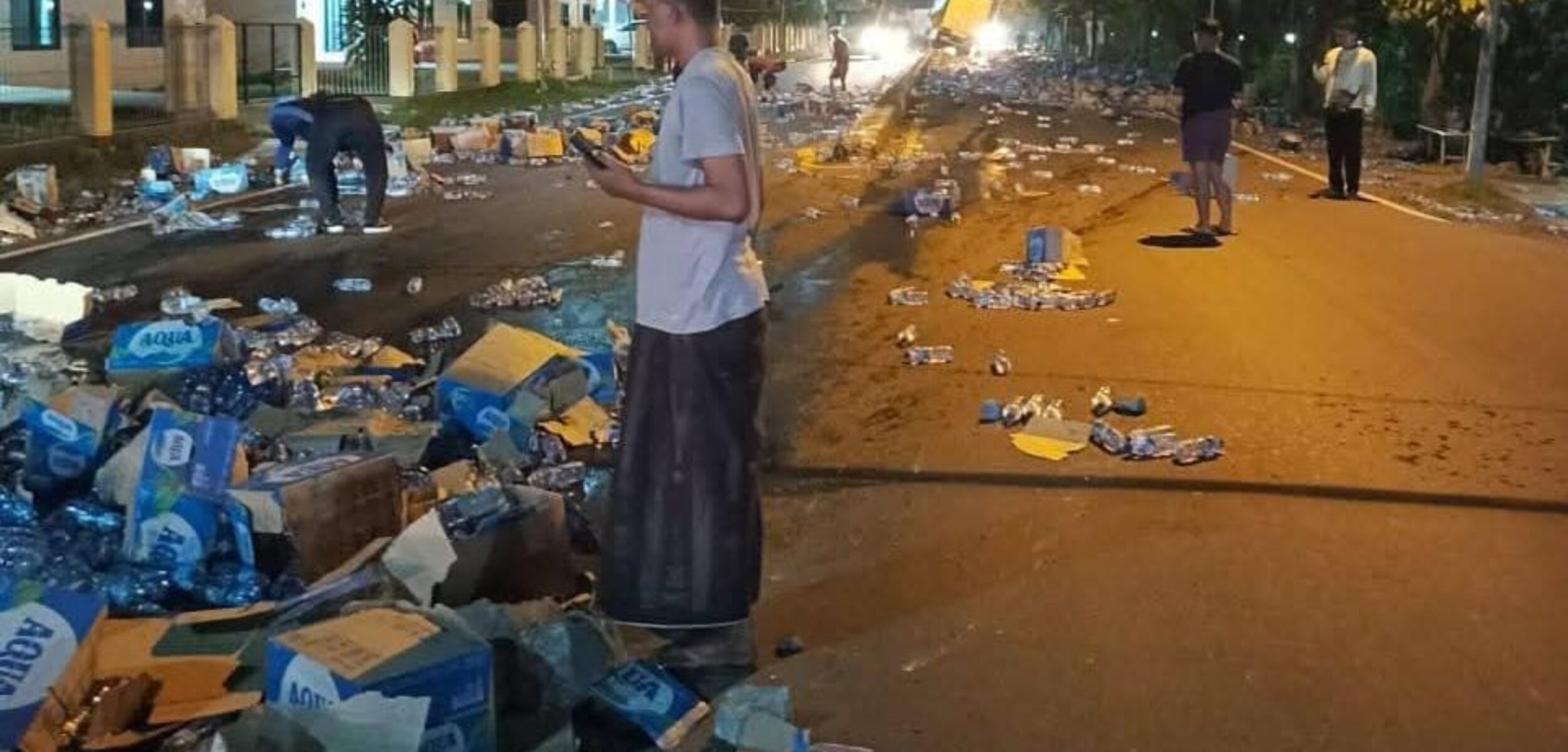 Air mineral berhamburan di jalan depan SPN Polda Jatim akibat laka lantas, Selasa (4/2/2025) dini hari (Redaksi / Kabarterdepan.com)