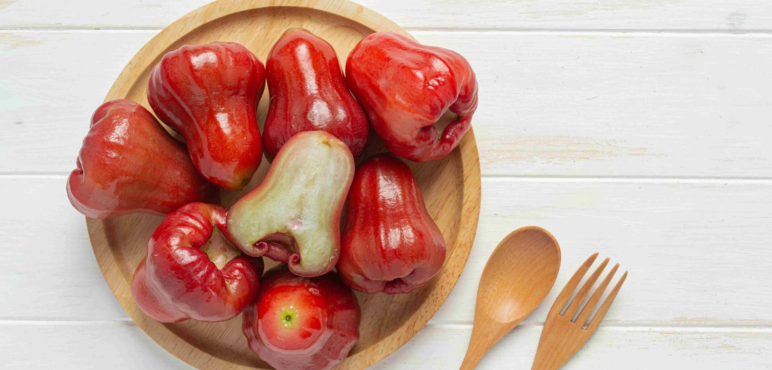 rose apple white wooden surface 1 11zon